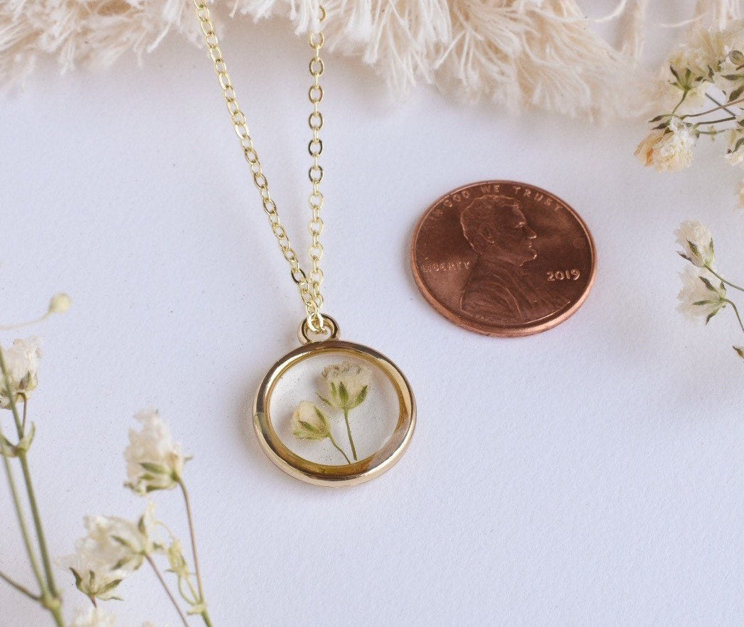 A custom gold resin necklace with flowers. Flowers are from a wedding bouquet, funeral, anniversary, graduation. Handmade pressed flower preservation jewelry gift.