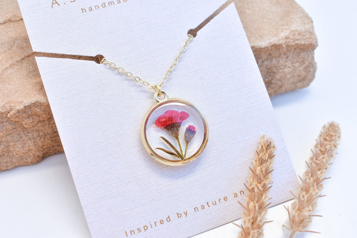 A custom gold resin necklace with flowers. Flowers are from a wedding bouquet, funeral, anniversary, graduation. Handmade pressed flower preservation jewelry gift.
