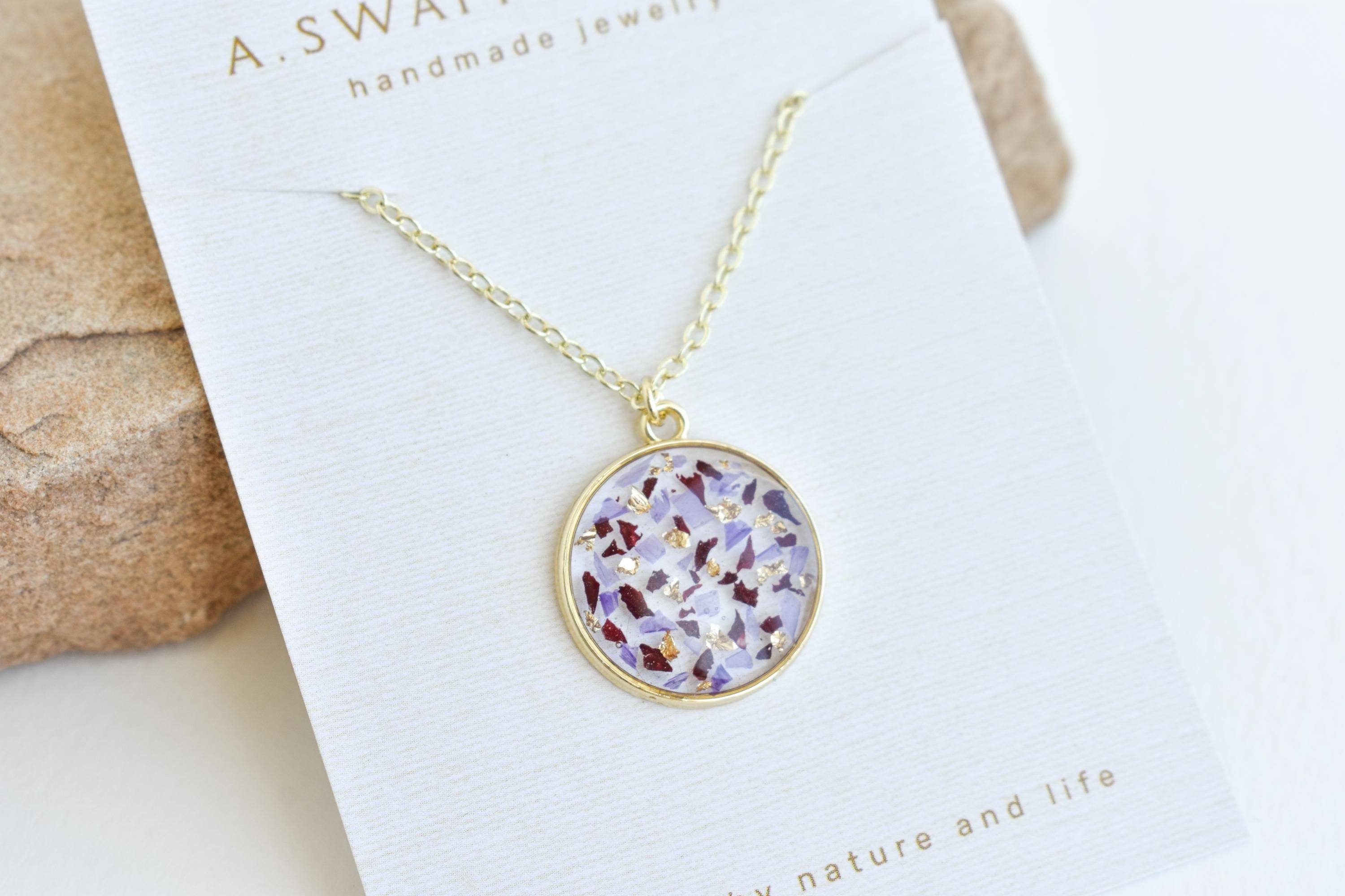 A custom gold resin necklace with flowers. Flowers are from a wedding bouquet, funeral, anniversary, graduation. Handmade pressed flower preservation jewelry gift.
