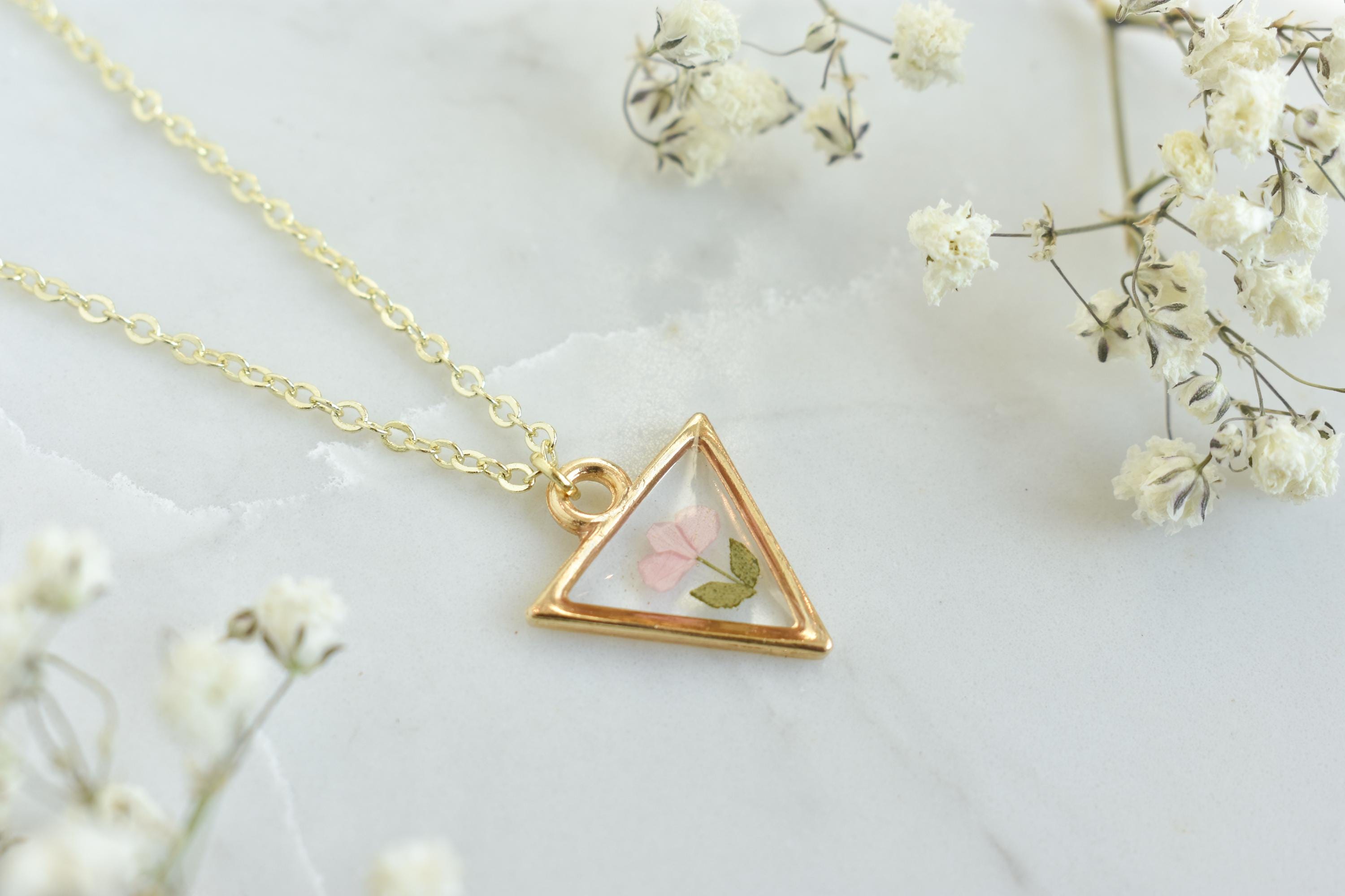A custom gold resin necklace with flowers. Flowers are from a wedding bouquet, funeral, anniversary, graduation. Handmade pressed flower preservation jewelry gift.