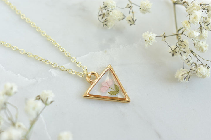 A custom gold resin necklace with flowers. Flowers are from a wedding bouquet, funeral, anniversary, graduation. Handmade pressed flower preservation jewelry gift.